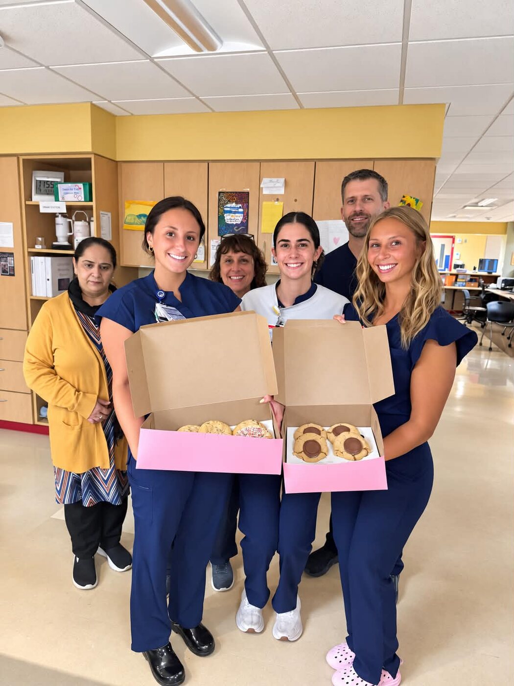 Nurses on D7 holding boxes of donated cookies