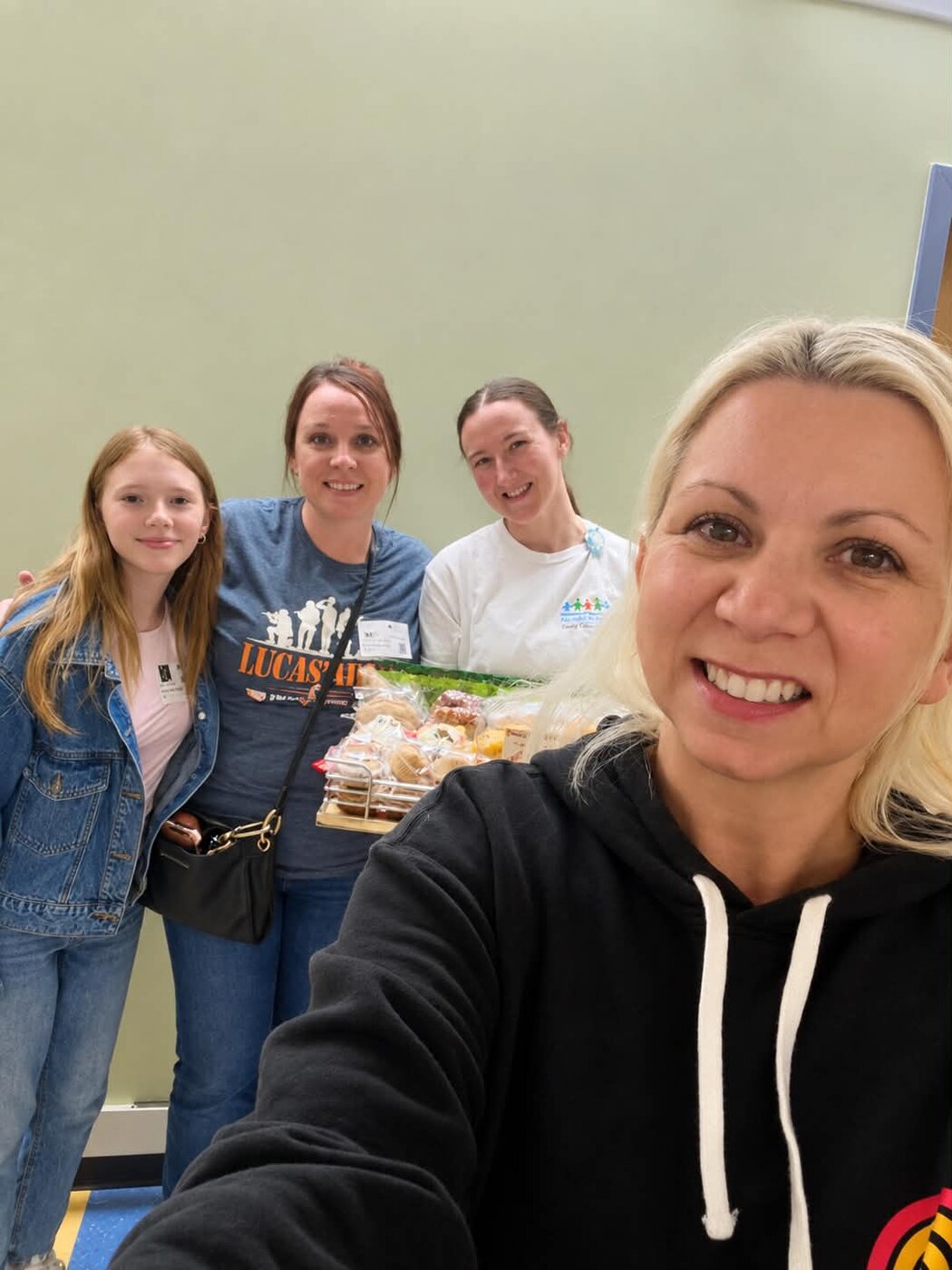 Volunteers with a tray of pastries delivered to the D7 nourishment room