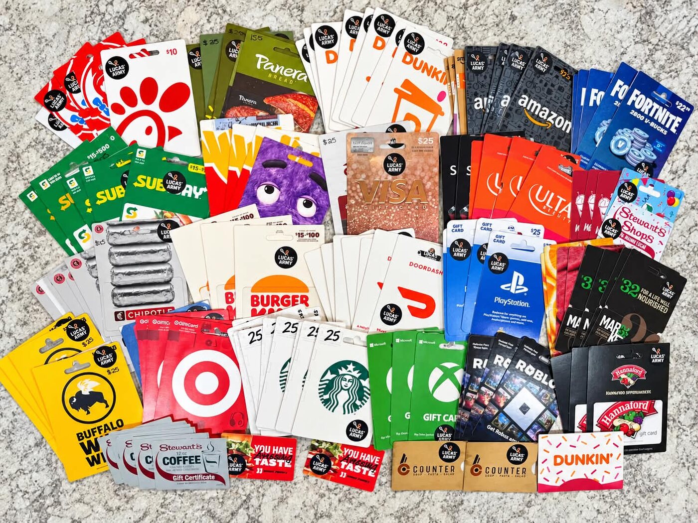 A large spread of donated gift cards tagged with Lucas' Army stickers
