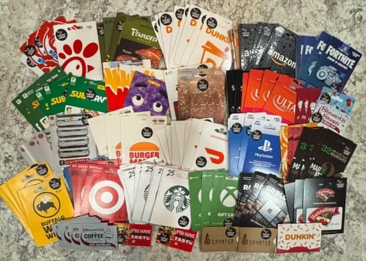 Dozens of donated gift cards laid out on a counter
