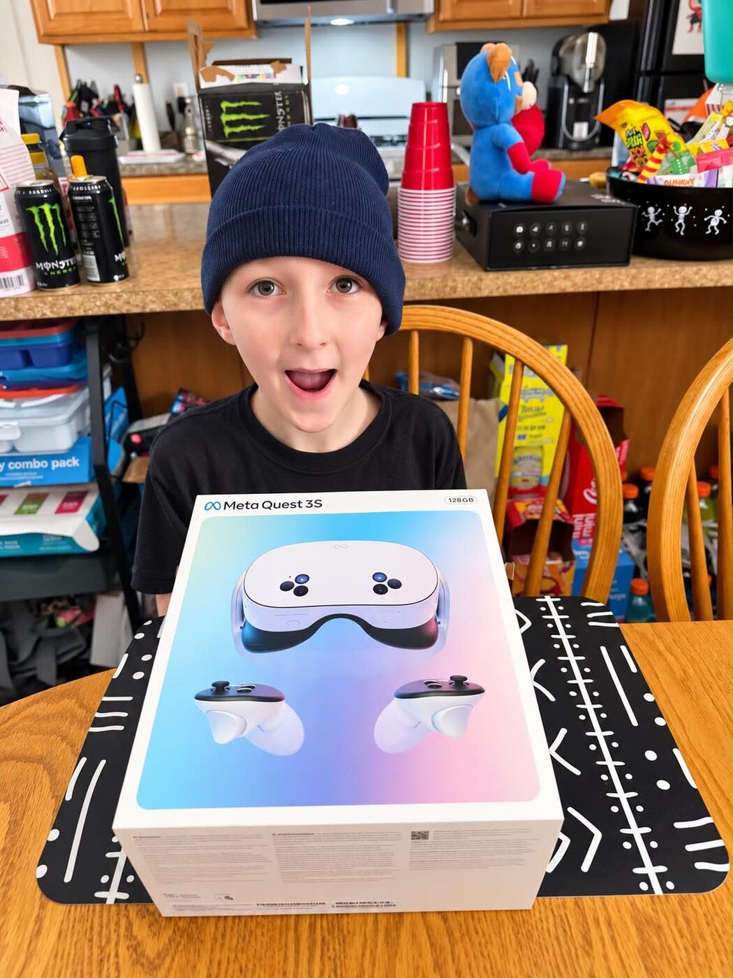 Dylan grinning with excitement behind his new Meta Quest 3S headset box