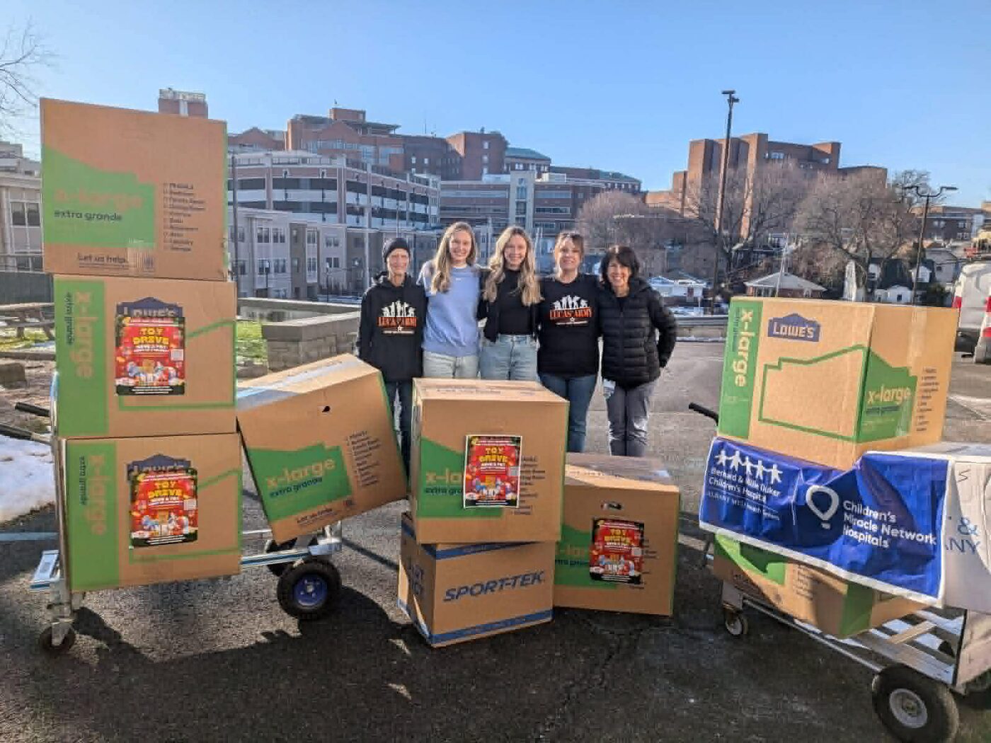 Volunteers with carts of donated toys outside the children's hospital